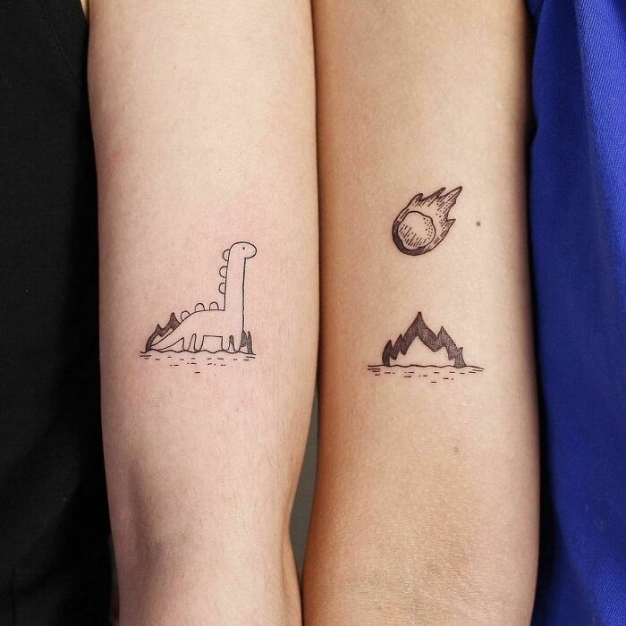 Dinosaur and meteor best friend tattoos on forearms, representing friendship and shared themes.