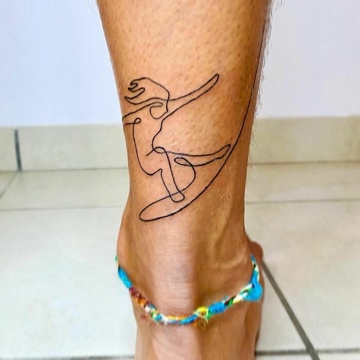 Minimalist line tattoo of an abstract figure on a person's ankle, showcasing unique line art for enthusiasts.