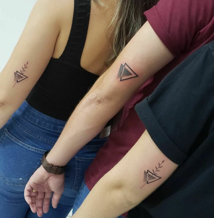 Siblings display matching triangle tattoos on their arms, symbolizing simple brother and sister bond.