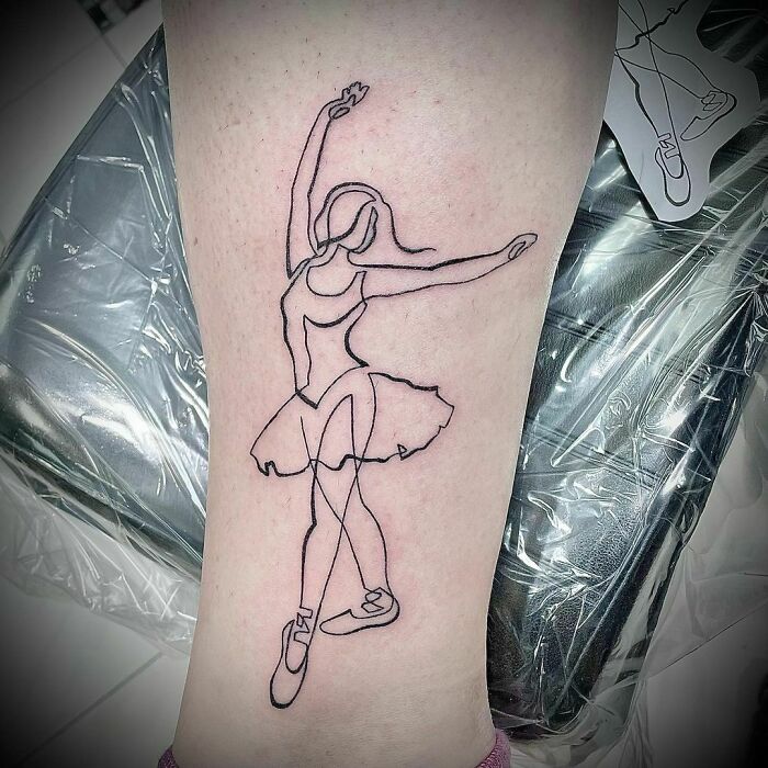 Minimalist line tattoo of a ballerina on a forearm, showcasing unique line design for tattoo ideas enthusiasts.