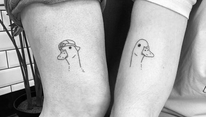 BFF tattoos of ducks with hats on arms, showcasing friendship and matching tattoo ideas.