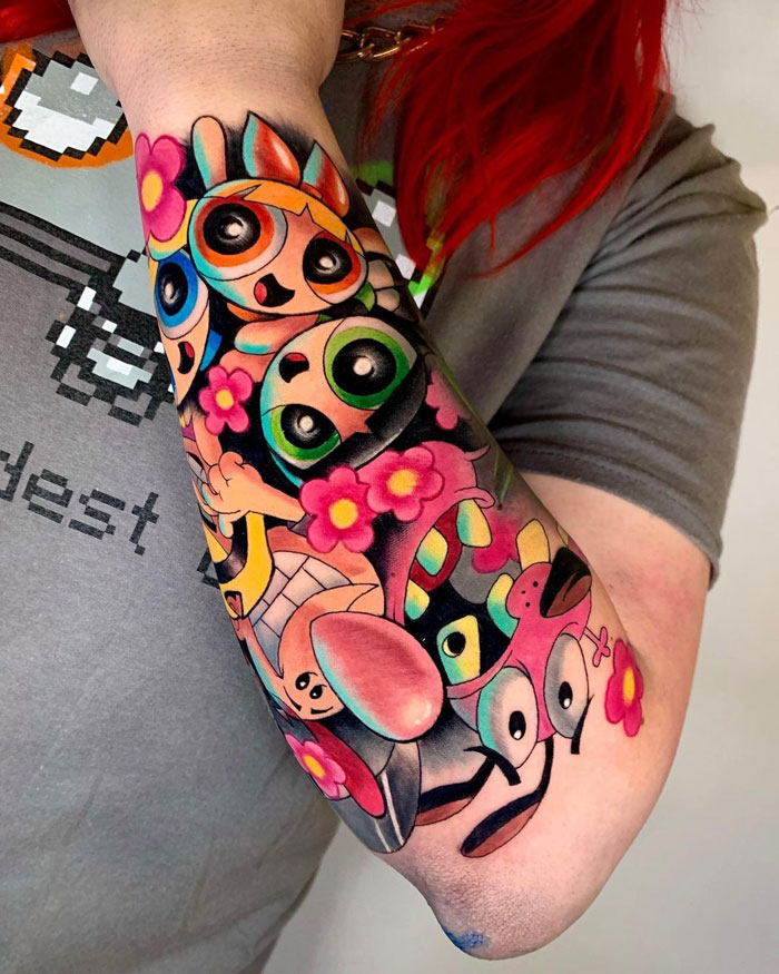 Colorful cartoon tattoo inspired by classic animated shows on a forearm, featuring vibrant character designs and floral accents.