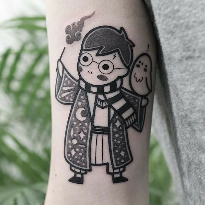 Cute Harry Potter tattoo with wand and owl, featuring iconic glasses and scarf, ideal for fans.