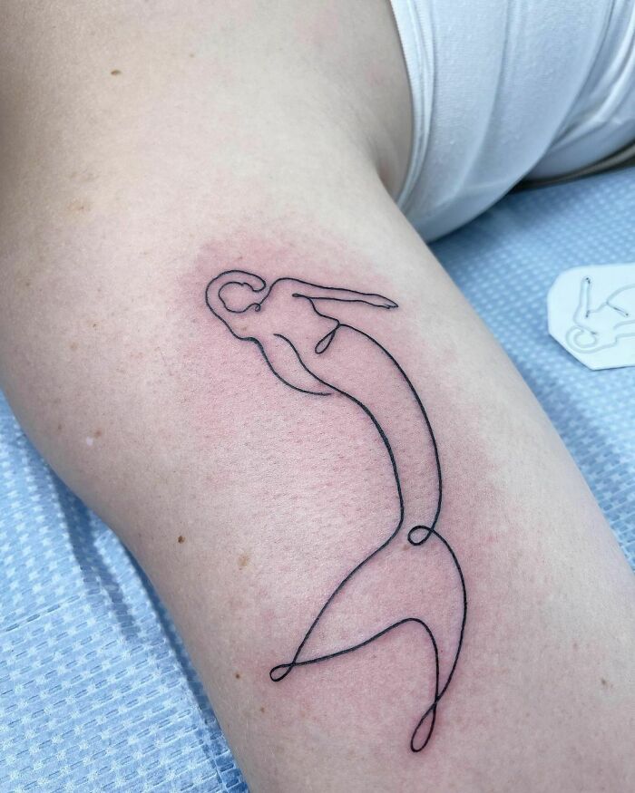 Minimalism enthusiasts will appreciate this unique line tattoo of a mermaid on an arm, showcasing simplicity and elegance.