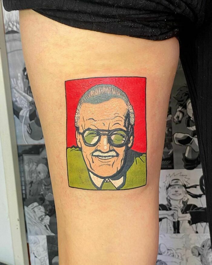 Marvel tattoo featuring an iconic comic book creator Stan Lee in a colorful design on an arm.
