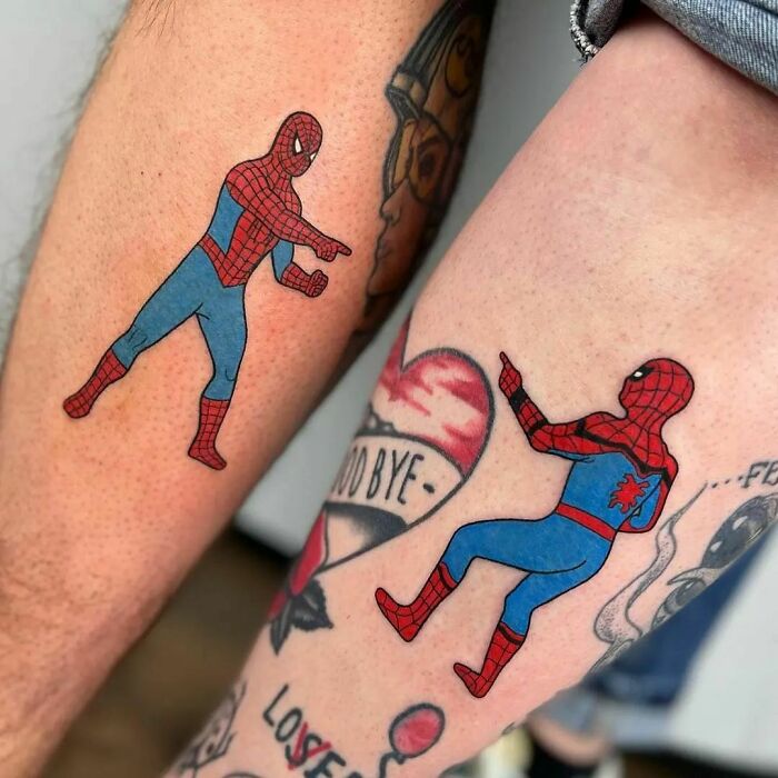Spider-Man tattoos on legs pointing at each other, showcasing cool Marvel designs.