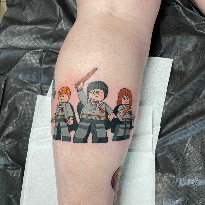 LEGO-style Harry Potter tattoo on leg, featuring Ron, Harry, and Hermione, ideal for any Potterhead.