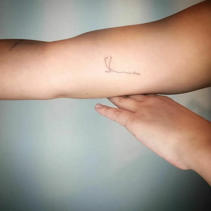 Minimal line tattoo on arm, showcasing a simple and elegant design for minimalism enthusiasts.