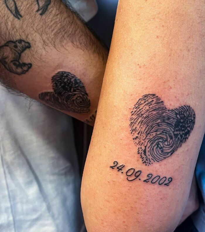 Matching brother and sister tattoos featuring heart-shaped fingerprints and a date.