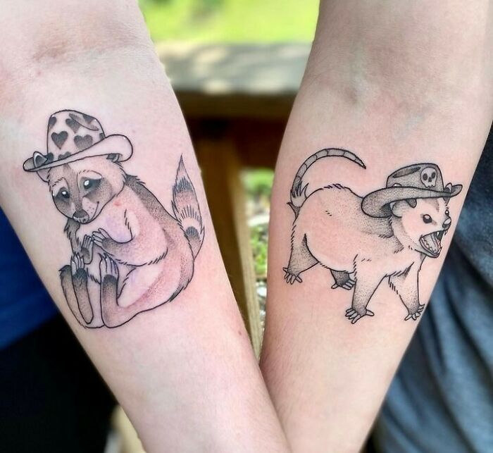 Matching BFF tattoos of a raccoon and opossum wearing hats, symbolizing friendship and shared adventures.