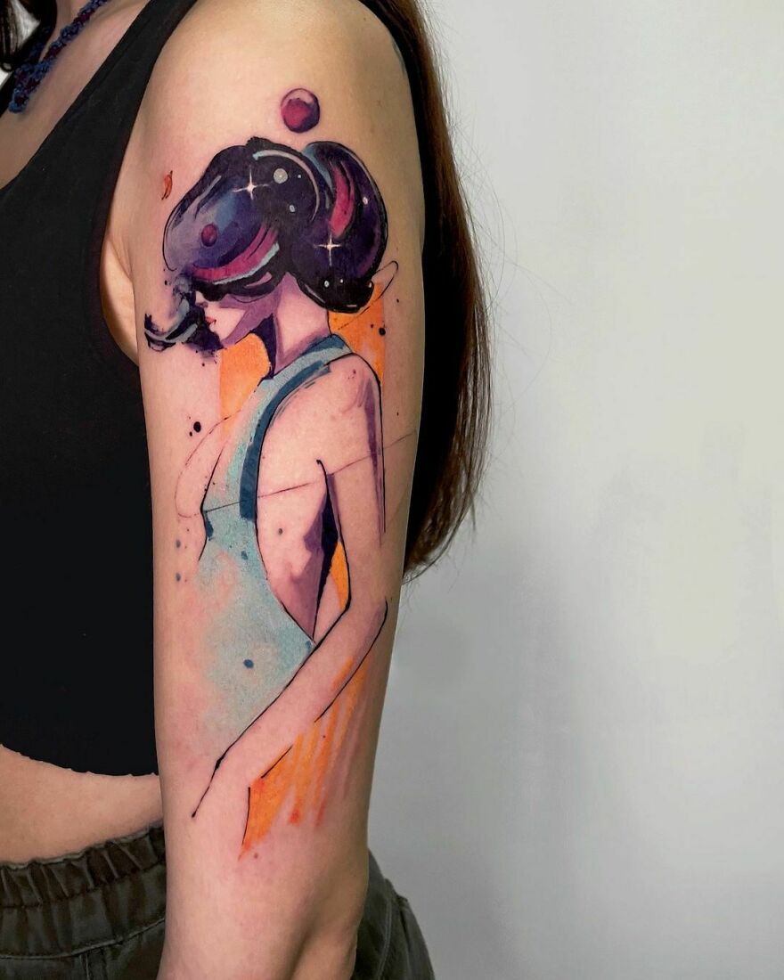Watercolor tattoo of an abstract woman on an arm, featuring bold colors and stylish design.