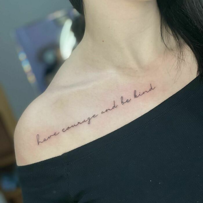 Creative word tattoo on collarbone reading "have courage and be kind," in elegant script for inkspiration.