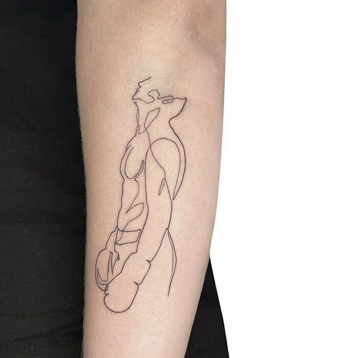 Single-line tattoo of an abstract human figure on a forearm, showcasing minimalist design and creativity.