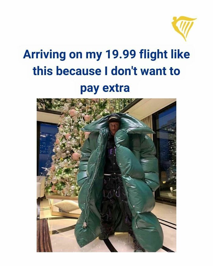 Person wrapped in large green puffer coat beside Christmas tree, caption referencing cheap Ryanair flight and paying extra.