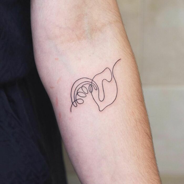 Single-line abstract tattoo of lips and leaves on a forearm.