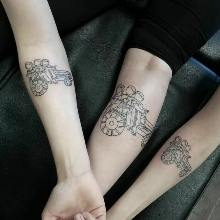 Matching brother and sister tattoos on forearms, featuring a nostalgic design of children on a wagon.