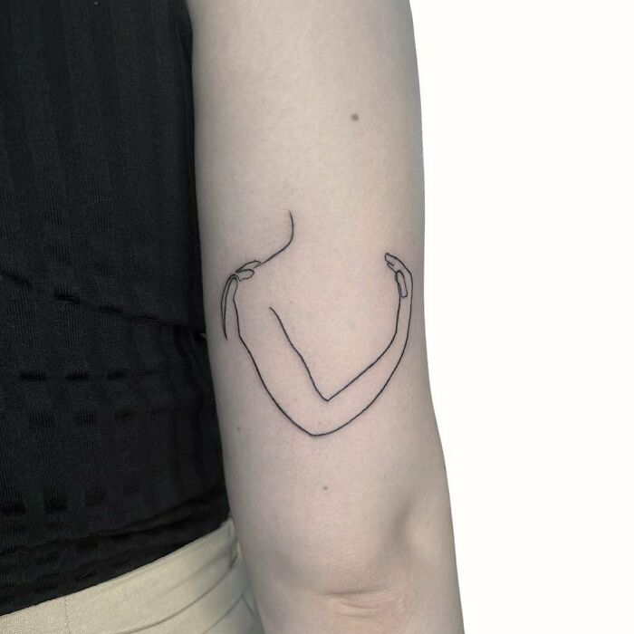 Minimalism line tattoo of an abstract arm on a person's inner forearm.