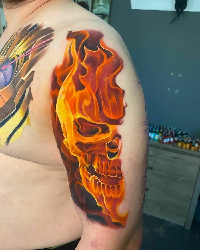 Marvel tattoo featuring Ghost Rider's flaming skull on a person's arm in vibrant colors.