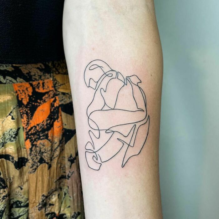 Single-line tattoo on forearm, showcasing a minimalist and fine-line art design.