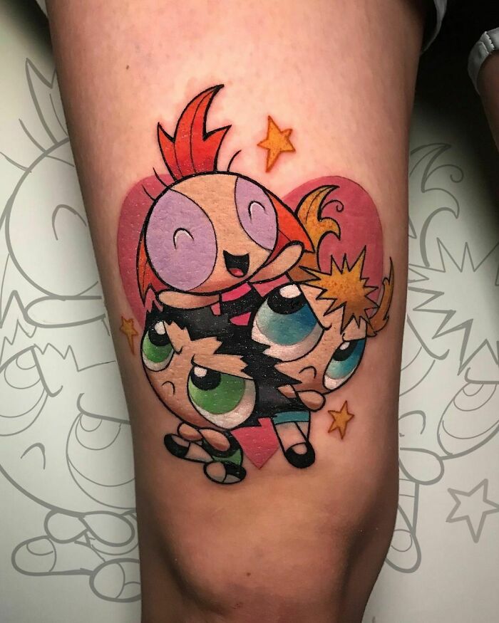 Cartoon tattoo featuring colorful characters with stars, reminiscent of childhood favorites.