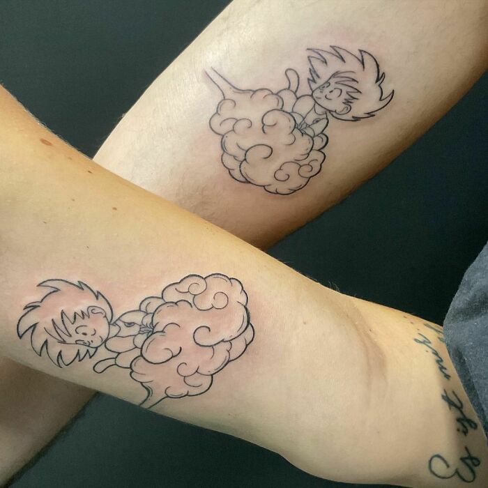 Matching brother and sister tattoos of a cartoon character on a cloud, symbolizing unity and connection.