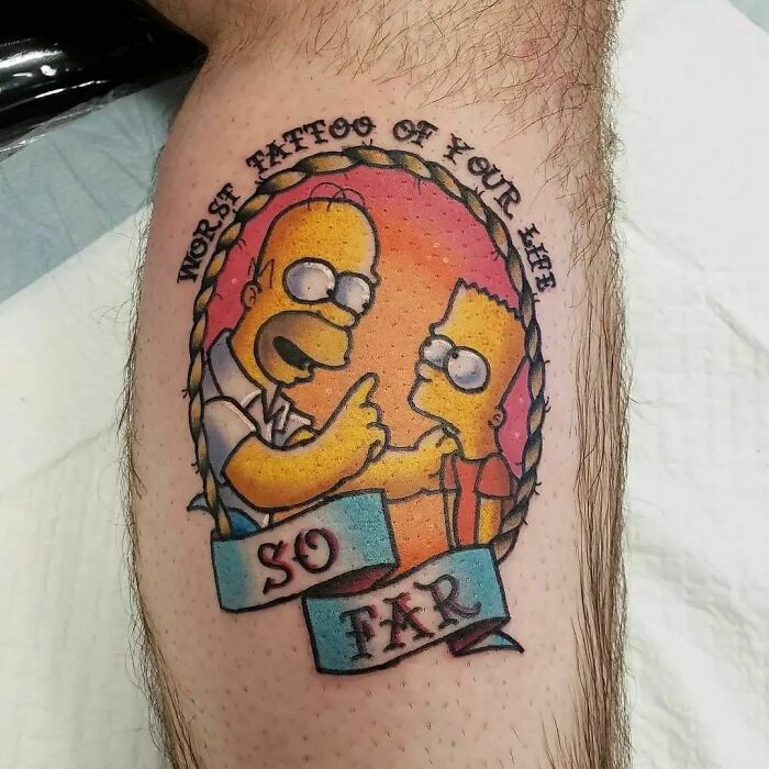 Cartoon tattoo of two iconic animated characters with "Worst Tattoo of Your Life" text on skin.