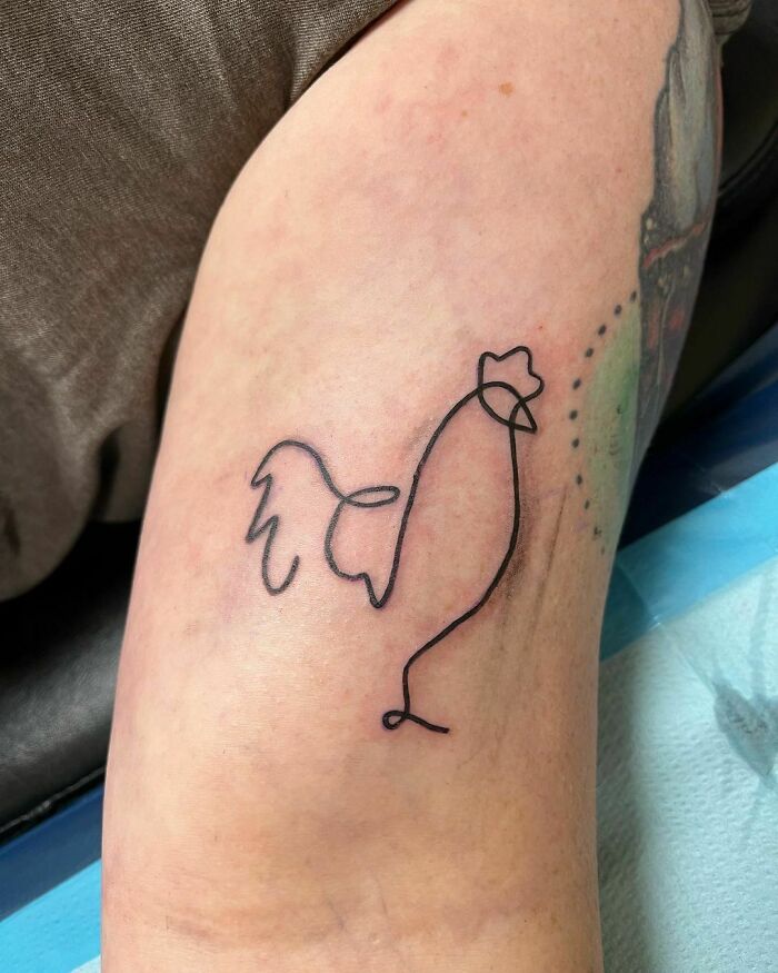 Minimalist line tattoo of a chicken on an arm, showcasing unique design for tattoo enthusiasts.