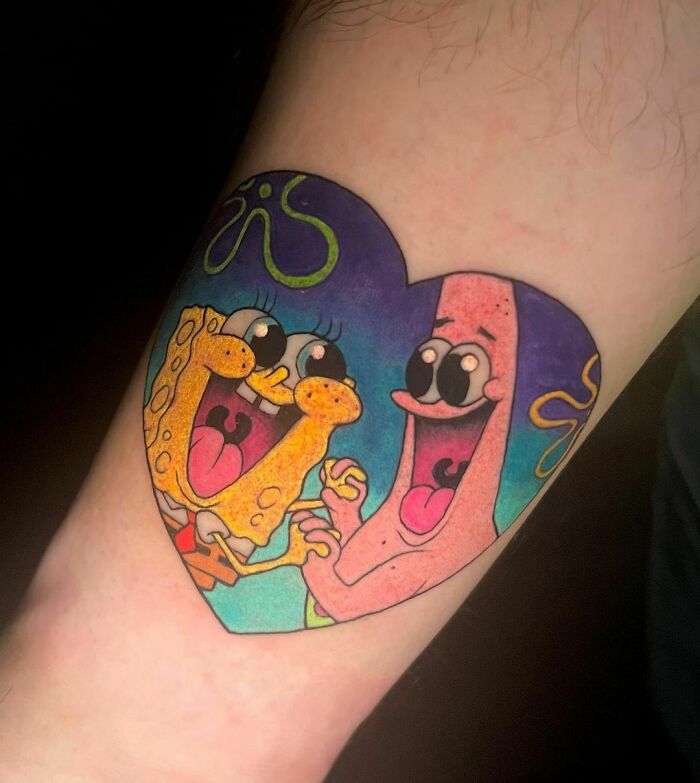Cartoon tattoo of SpongeBob and Patrick holding hands in a heart shape for nostalgic vibes.