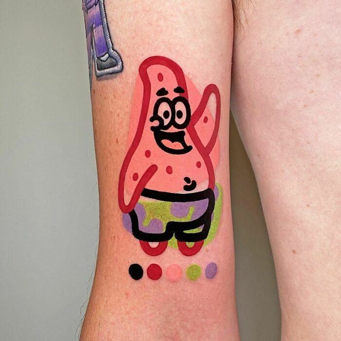 Cartoon tattoo of a happy starfish character Patrick Star on an arm with colorful shading samples below.