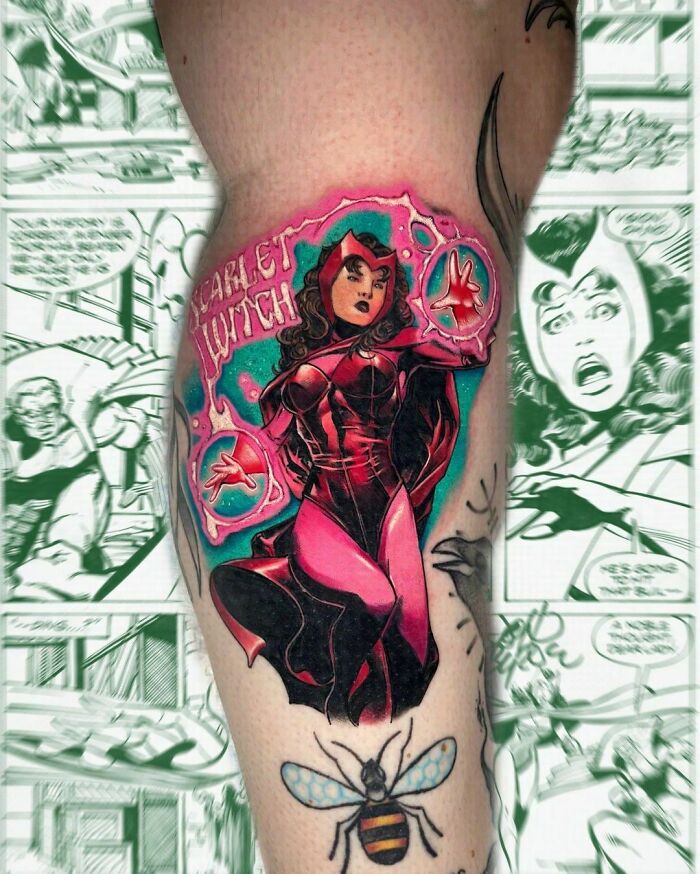 Scarlet Witch Marvel tattoo on thigh with vivid colors and comic background.