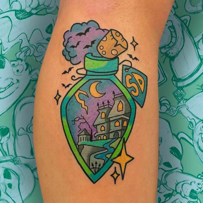 Cartoon tattoo with a haunted house in a potion bottle design, evoking childhood favorites.