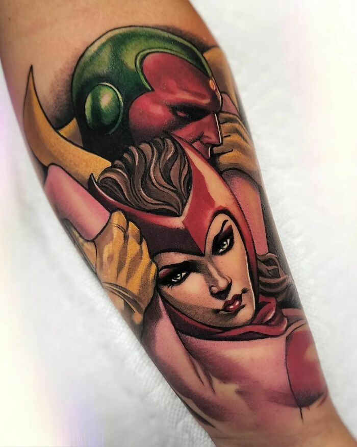 Marvel tattoo featuring detailed characters in vivid colors on forearm.