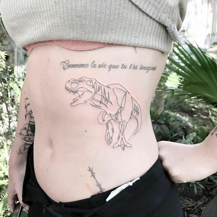 Minimal line tattoo of a T-rex skeleton on a person's side, showcasing minimalist tattoo design.