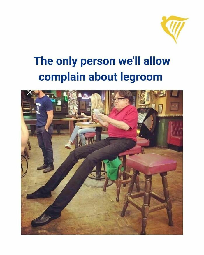 Person with exaggeratedly long legs sitting on a stool, referencing Ryanair's social media roast about legroom.