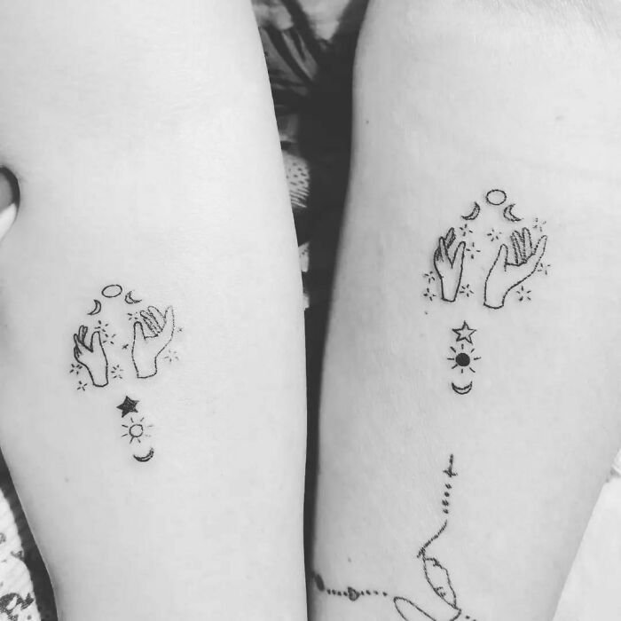 Matching simple brother and sister tattoos featuring hands and celestial symbols.