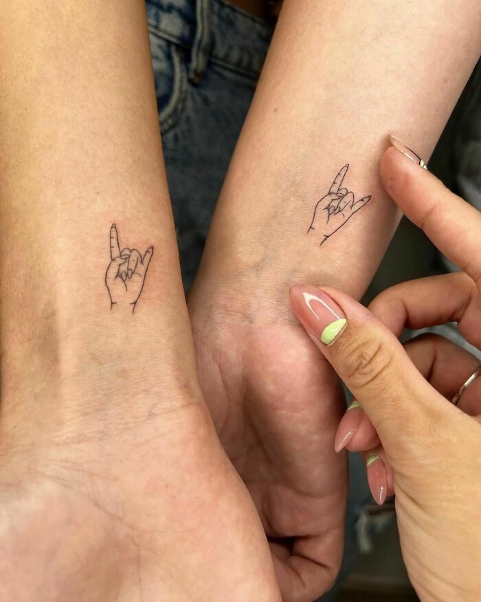 Matching hand tattoos symbolizing friendship on two forearms, a perfect best friend tattoo idea.