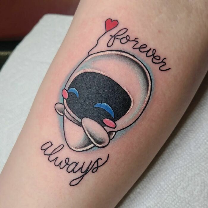 Cartoon tattoo of a cute character with the words "forever always" in stylized script.