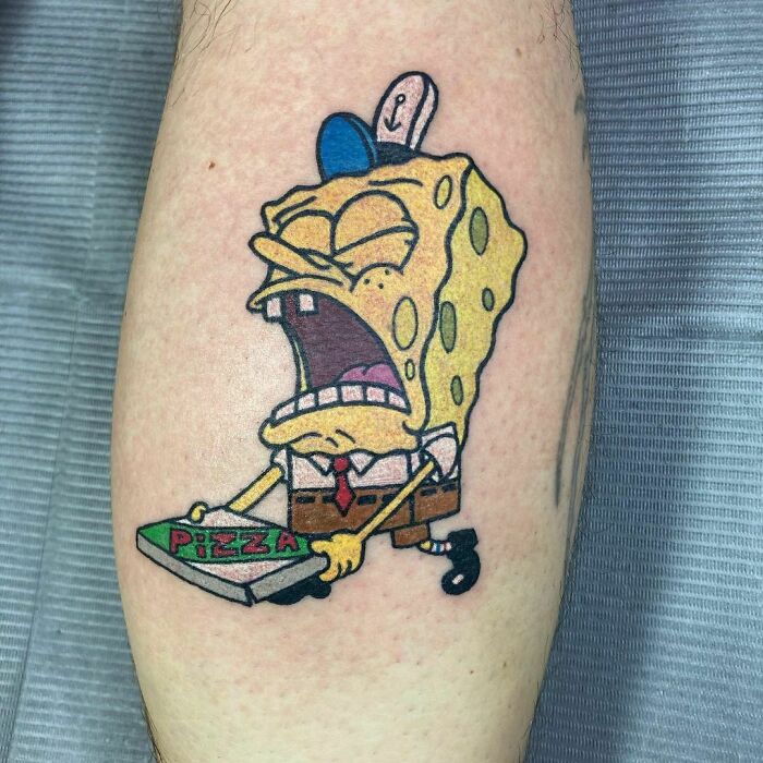 Cartoon tattoo of SpongeBob holding pizza, capturing nostalgia with vibrant colors and expressive design.
