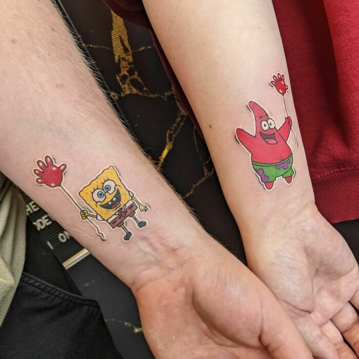 Cartoon tattoos of a yellow sponge and pink starfish character on forearms, celebrating childhood favorites.