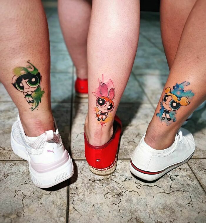 Cartoon tattoos on legs featuring childhood favorites in colorful designs, with white and red shoes.