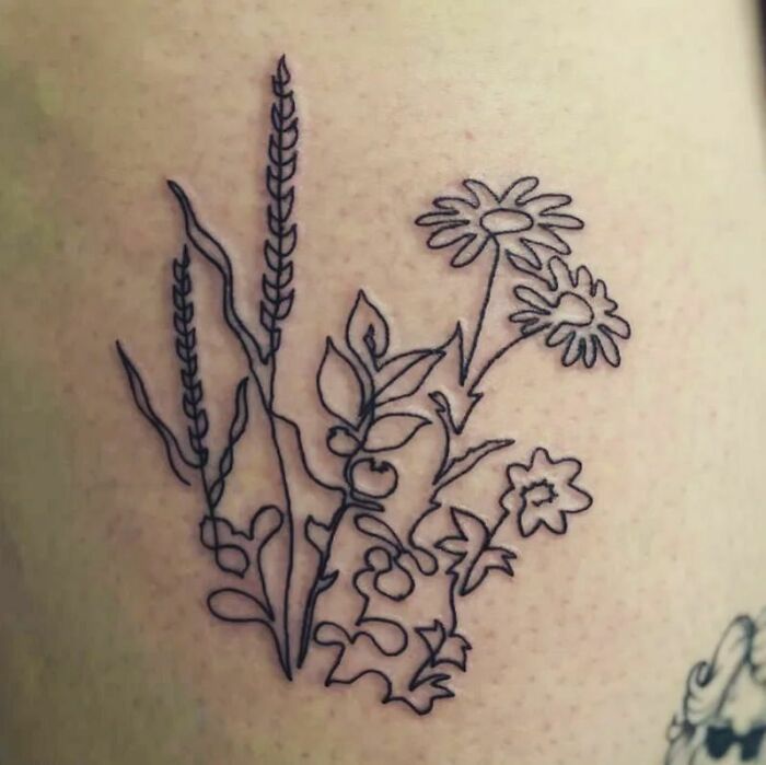 Minimal line tattoo of flowers and leaves, showcasing unique tattoo ideas for minimalism enthusiasts.