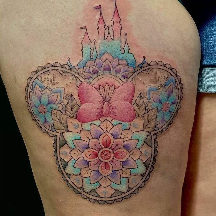 Colorful cartoon tattoo featuring a castle and floral designs inspired by childhood's favorites.