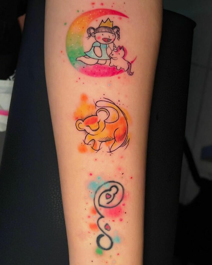 Colorful watercolor tattoos of a girl and moon, bear, and abstract design on an arm, showcasing inkspiration.