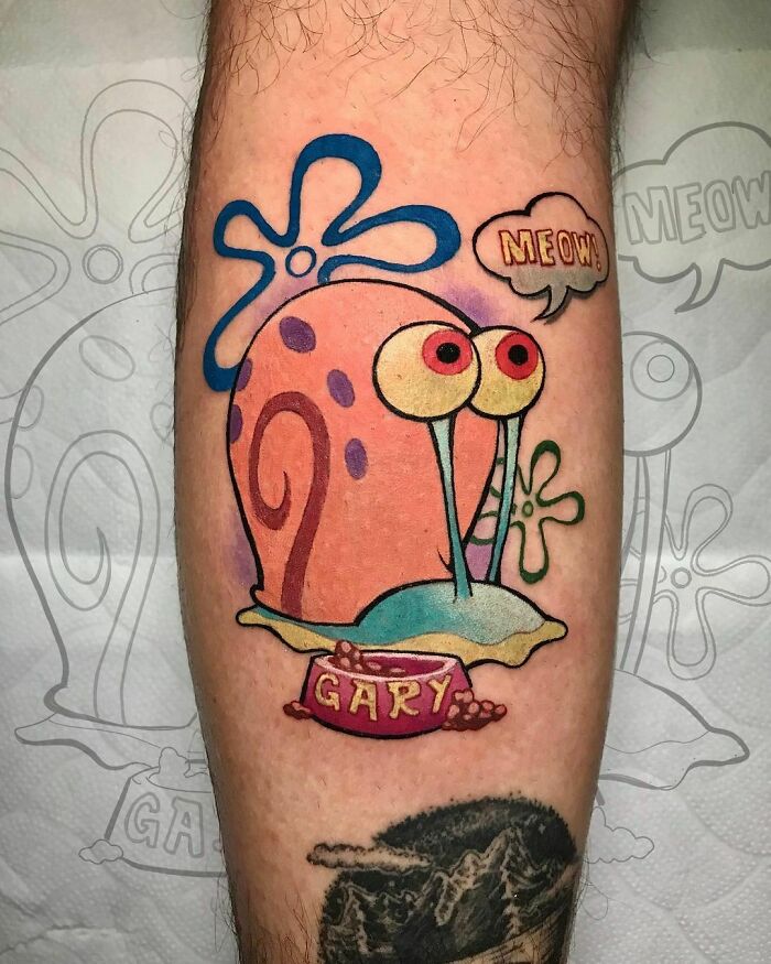 Colorful cartoon tattoo of Gary the snail on a person's leg.