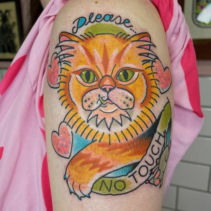 Cat tattoo with "Please No Touch" text, featuring a bright orange cat and pink heart accents, celebrating furry friends.
