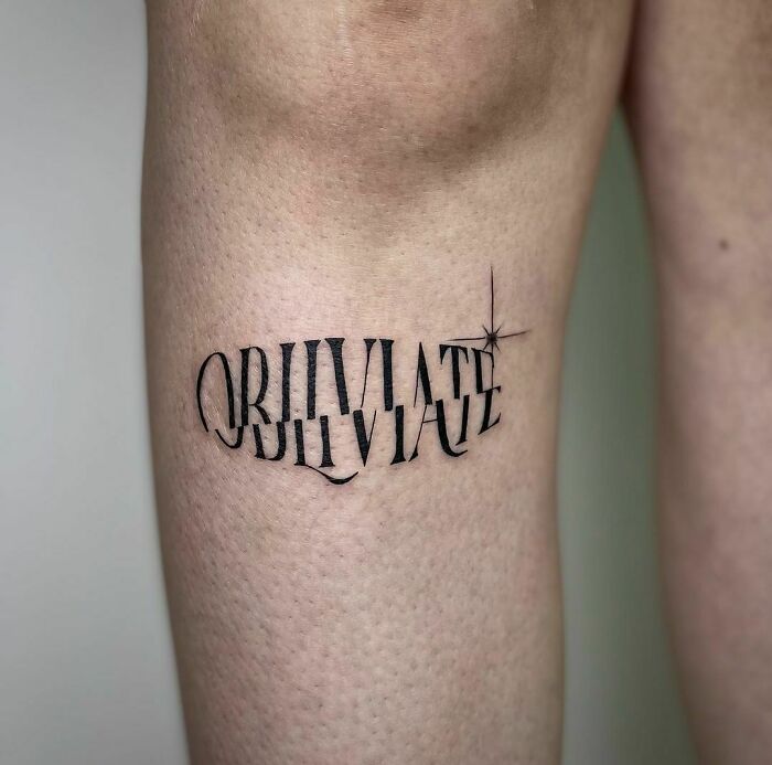 "Obliviate tattoo on a leg, inspired by Harry Potter, with a star accent."