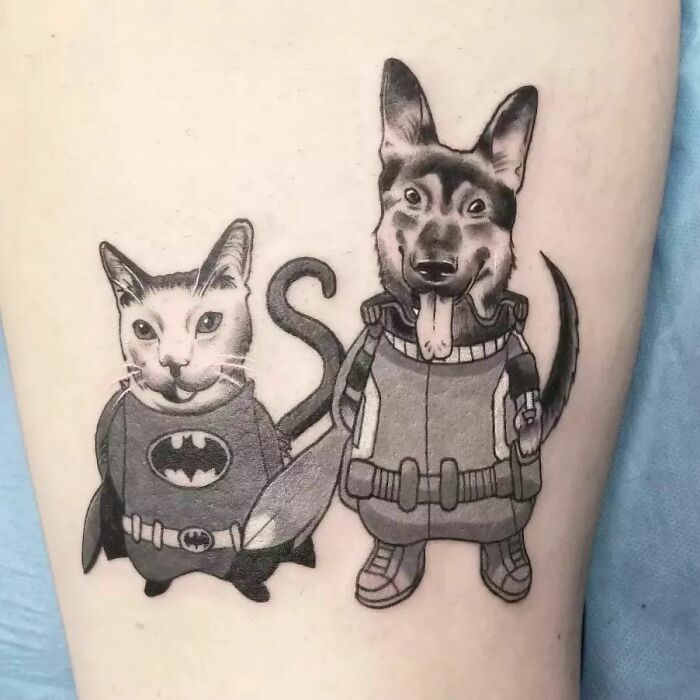 Pet tattoos featuring a cat in a Batman costume and a dog in a Rocket Raccoon outfit celebrating the human-animal bond.
