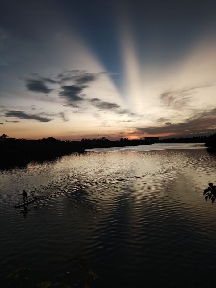 Man Rows Before Total Sunset