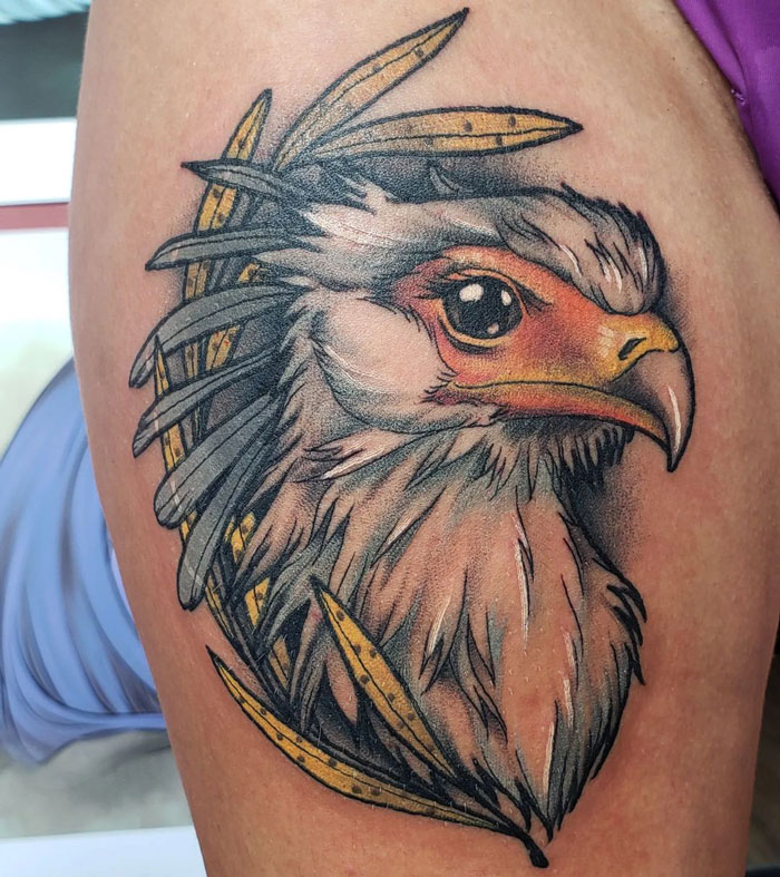 Realistic animal tattoo featuring an artistically detailed bird with vibrant colors, emphasizing simplicity and beauty.