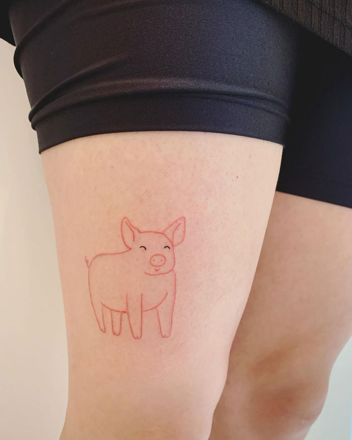 Cute pig outline tattoo on thigh showcasing animal tattoo creativity.